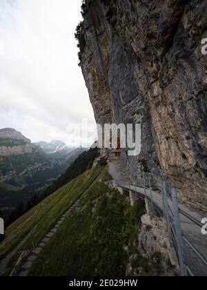 Famous guesthouse Aescher-Wildkirchli built into limestone cliff wall Alpstein alpine mountains Appenzell Innerrhoden Switzerland Stock Photo