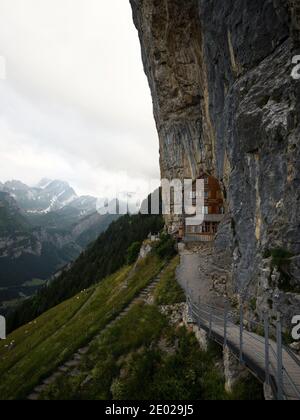 Famous guesthouse Aescher-Wildkirchli built into limestone cliff wall Alpstein alpine mountains Appenzell Innerrhoden Switzerland Stock Photo