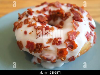 Closeup of Mouthwatering Maple-glazed Bacon Doughnut on a Plate Stock Photo