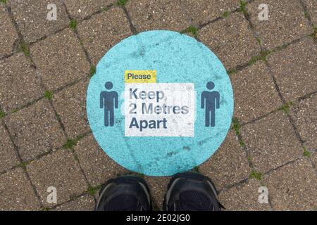 'Keep 2 metres apart' sign on the ground reminding people to socially distance during the 2020 Covid-19 pandemic, Windsor, Berkshire, UK. Stock Photo
