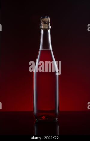 Bottle of Lambrusco wine  on red dark background. Stock Photo