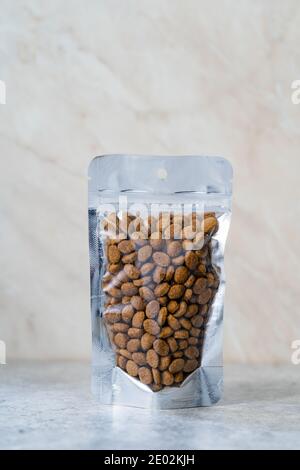 Packed Dog Food For Sale in Plastic Package Container. Ready to Use. Stock Photo