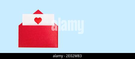 Banner red open envelope with a sheet of paper with a heart on a blue background with copyspace. Valentine's day holidays concept and love notes Stock Photo