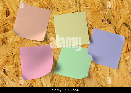 Blank sticky notes on a wooden wall Stock Photo