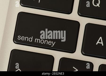 A computer and key to send money Stock Photo