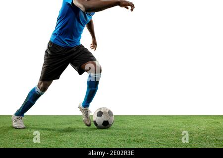 Close up legs of professional soccer, football player fighting for ball on field isolated on white background. Concept of action, motion, high tensioned emotion during game. Cropped image. Stock Photo