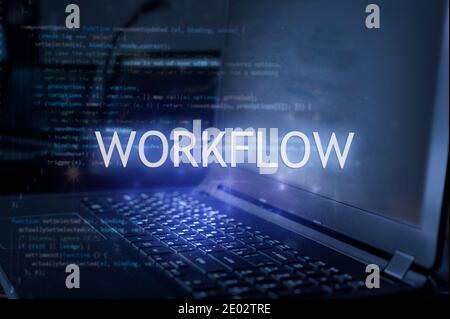 Workflow inscription against laptop and code background. Technology concept. Stock Photo