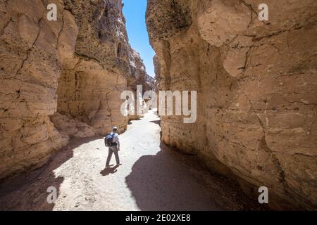Tourist inside Sesriem Canyon, Namib Naukluft Park, Namibia Stock Photo