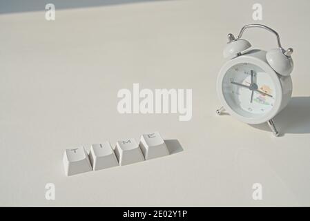 Time word composed of keyboard keys, clock on grey background, copy space Stock Photo