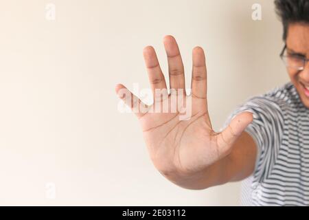 young man show stop sigh isolated in black  Stock Photo