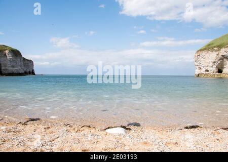 North Landing is a small beach cove surrounded by the chalk white cliff headlands of Flamborough Cliffs Stock Photo