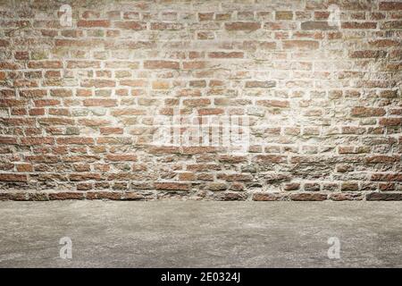 Old brick wall and concrete floor. Empty interior design. Old grungy texture background Stock Photo