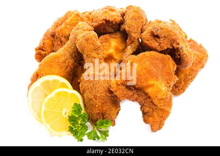 fried chicken pieces with lemon and parsley isolated on white background Stock Photo