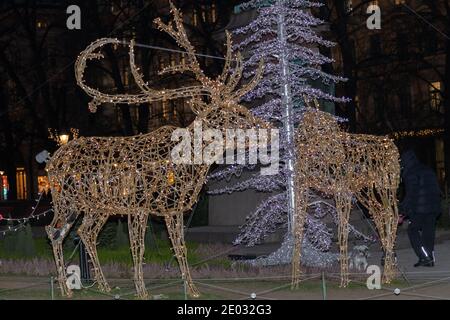 Helsinki, Finland December 29, 2020 Traditional decorative Christmas tree and reindeer with sleigh on Bulvardi street. High quality photo