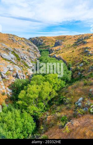 Valley of Ida Burn river at Central Otago Railway bicycle trail in New Zealand Stock Photo