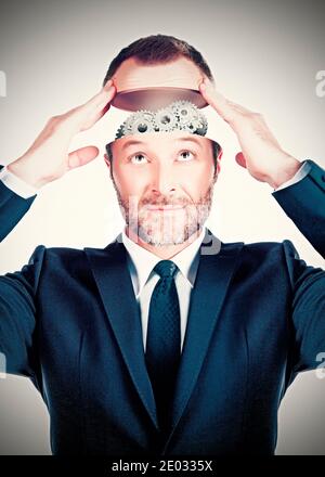 Conceptual image of a businessman showing gears in his head Stock Photo