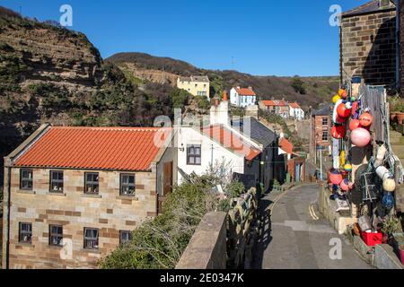 Staithes harbour, a once important fishing port, also known for its unique and colourful 'cobles' fishing boats that still fish lobster and mackeral. Stock Photo