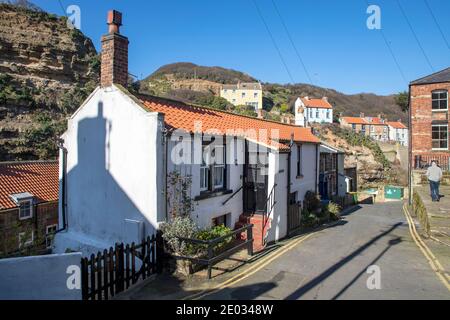 Staithes harbour, a once important fishing port, also known for its unique and colourful 'cobles' fishing boats that still fish lobster and mackeral. Stock Photo