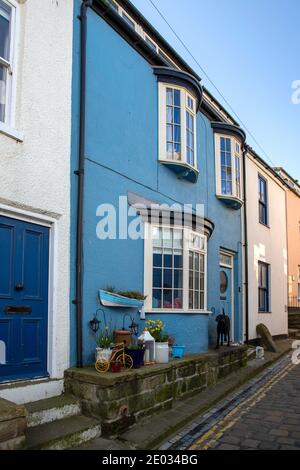 Staithes harbour, a once important fishing port, also known for its unique and colourful 'cobles' fishing boats that still fish lobster and mackeral. Stock Photo