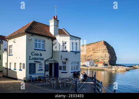 Staithes harbour, a once important fishing port, also known for its unique and colourful 'cobles' fishing boats that still fish lobster and mackeral. Stock Photo