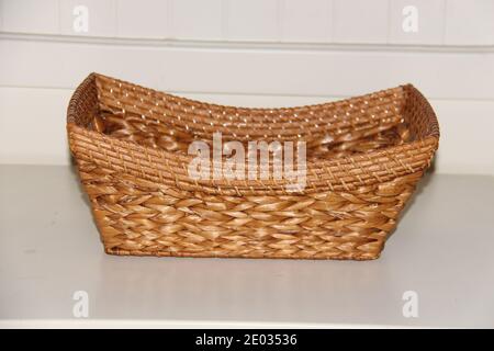 Wicker boat shape basket, isolated on white background. Traditional handicraft Stock Photo