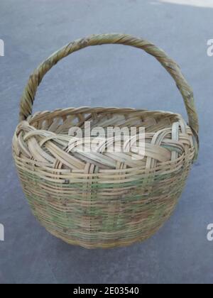 Closeup of handmade bamboo picnic basket, front view of empty wicker basket Stock Photo