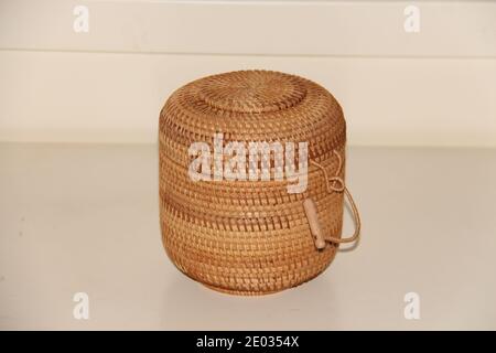 Braiding small food box with a round lid. Handwoven wicker basket Stock Photo