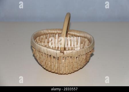 Closeup of handmade picnic basket with bamboo, empty wicker basket isolated on gray background Stock Photo