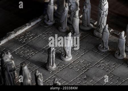 A black and white portrait of the beginning of a strategic game of chess with two pawns facing eachother. The duel will be fought on a stone chessboar Stock Photo