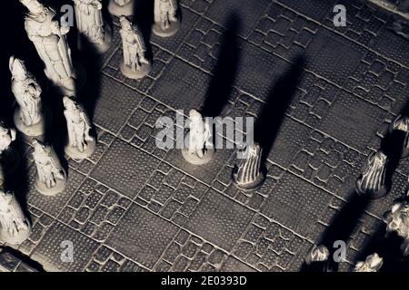 A portrait of the beginning of a match of chess. The first move has been made by placing two pawns in the center facing each other on a stone chessboa Stock Photo