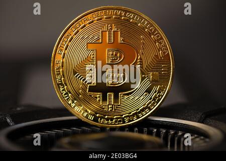 Gold bitcoin standing on crypto mining GPU computer hardware Stock Photo