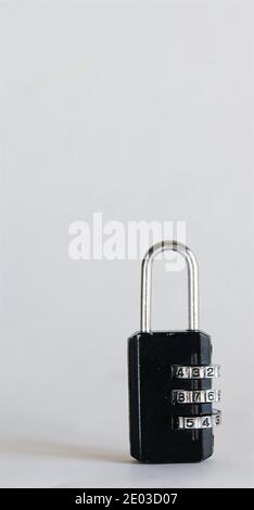 Black combination lock with digital scroll wheel isolated on white background, copy space, vertical composition Stock Photo