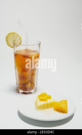 Mango pudding and iced tea with lemon, homemade refreshments, afternoon tea Stock Photo