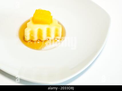 Homemade mango pudding with milk, mango mousse, dessert on white plate Stock Photo
