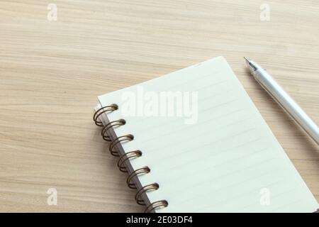 Open spiral-bound notebook and pen pn desk, blank for your text, workplace Stock Photo