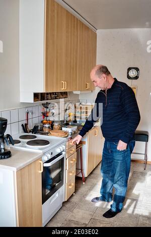 An elderly Swedish man at home in his kitchen Stock Photo