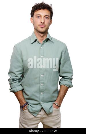 Vertical photo of a young man with shirt and the hands on the pockets facing the camera with a pride expression isolated on white Stock Photo