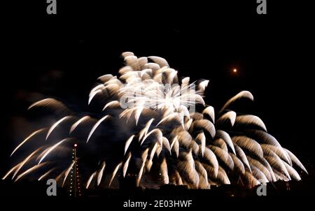 Fireworks. Colorful huge fireworks explode in dark sky background and house light in the far in Zurrieq, Malta Malta fireworks festival, 4 of July, In Stock Photo