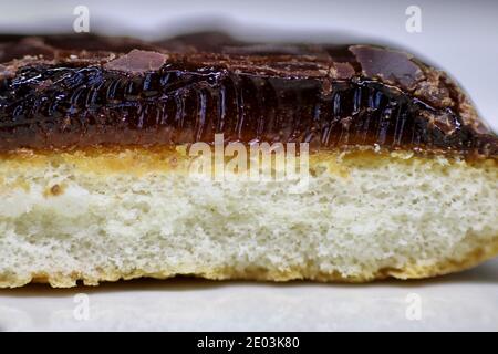 Macro Close up of a Sponge Cake Topped With Orange Jelly and a Thin Layer of Chocolate Stock Photo