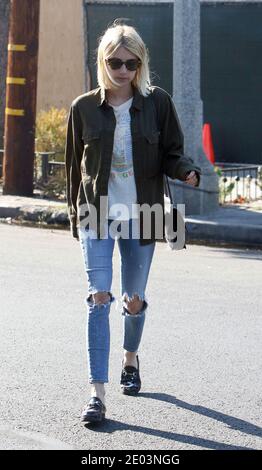 LOS ANGELES, CA - JULY 05: Emma Roberts cuts a stylish figure in distressed denim during solo shopping trip in LA. The 25-year-old actress opted for a white t-shirt decorated with a colorful image of an Egyptian pharaoh, which she paired with cropped denim jeans that were ripped at the knees on July 5, 2016 in Los Angeles, California. People:  Emma Roberts Credit: Hoo-me / MediaPunch Stock Photo