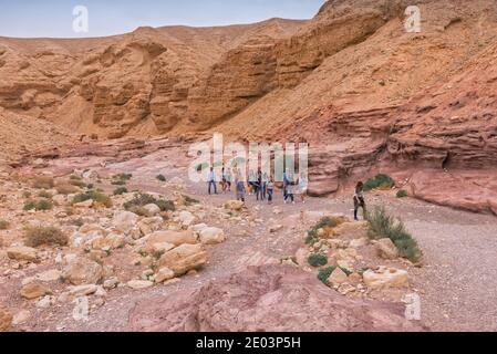 Travel to Israel. A group of Chinese tourists visiting the Red Canyon. Hiking in the Red Canyon is one of the most popular routes in the Eilat mountai Stock Photo