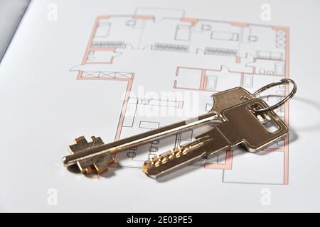 The metallic keys on the apartment draft. Real estate and property sale Stock Photo