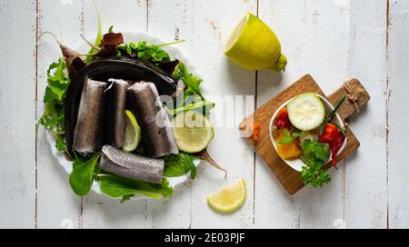 Typical Neapolitan raw fish dish of the Christmas period. Capitone, eel, cod and clams Stock Photo