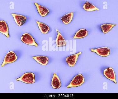 Cut figs on a blue background. Copy space. Flat lay. Top view. Stock Photo