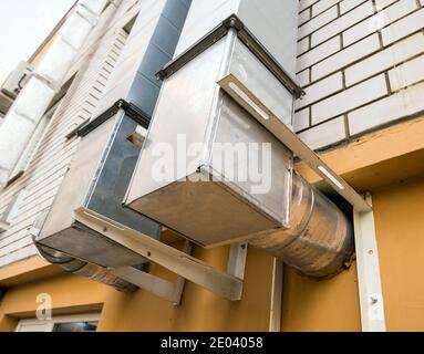 Air conditioning ventilation pipes on the wall of the house Stock Photo