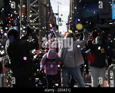 New York, United States. 29th Dec, 2020. Revelers react as confetti falls from the Hard Rock Cafe marquee as part of the annual New Year's Eve Confetti Test in Times Square in New York City on Tuesday, December 29, 2020. Due to the ongoing COVID-19 pandemic, New Years Eve 2021 in Times Square will not be open to the public this year. Photo by John Angelillo/UPI Credit: UPI/Alamy Live News Stock Photo