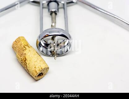 steel wing corkscrew with a perforated cork isolated on a white background. Stock Photo