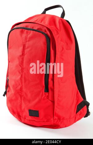 Red backpack with black details  isolated on white background. For school, traveling and free time. Stock Photo