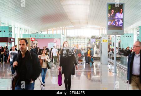 Barcelona, Spain, April 2019: people walking along the international departures corridor of El Prat airport in Barcelona, Spain Stock Photo