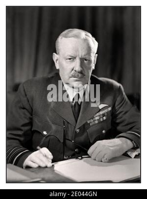 BOMBER HARRIS ARCHIVE Portrait Air Chief Marshal Sir Arthur Harris, Commander in Chief of Royal Air Force Bomber Command,  nicknamed ‘Bomber Harris” seated at his desk, smoking a cigarette at Bomber Command HQ. A controversial figure whose bombing tactics responded  to Nazi Luftwaffe Blitz terror bombing in the UK. Bomber Harris took the fight directly back to Adolf Hitler in Nazi Germany with huge success.  High Wycombe. 24 April 1944 Stock Photo